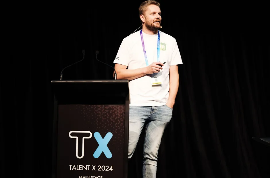 Kamal presenting on the main stage at Talent X 2024